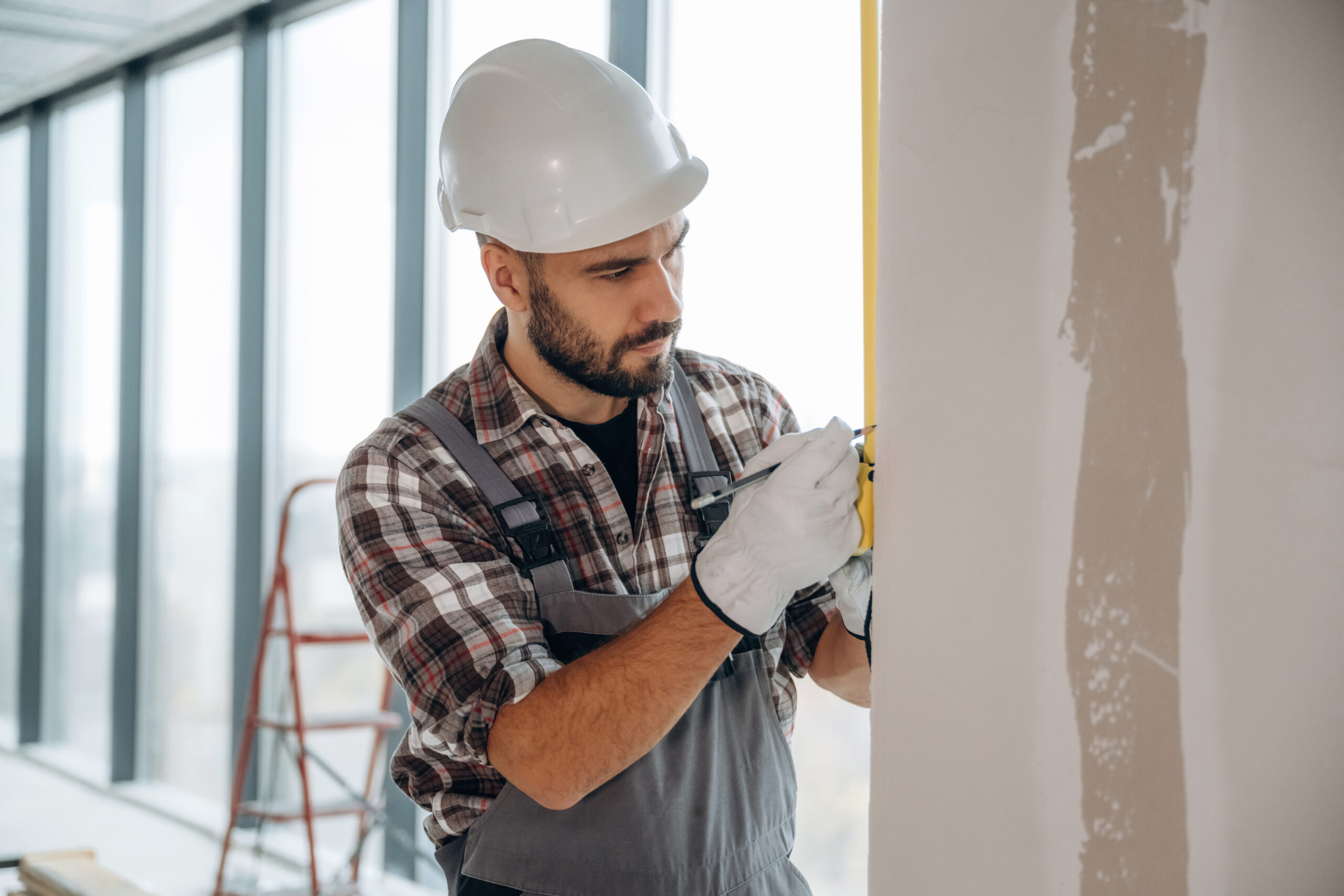 Focused on the work. A man is renovating an unfinished room.